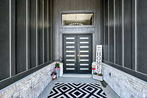 Property entrance featuring board and batten siding