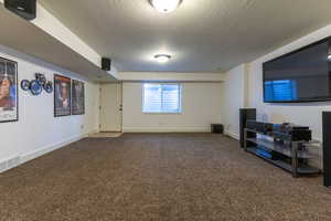 Interior space featuring carpet floors and a textured ceiling