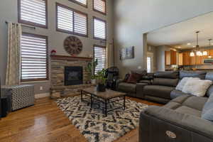 Living room featuring a fireplace, light hardwood / wood-style flooring, and a chandelier