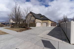 View of property exterior with a mountain view and a garage