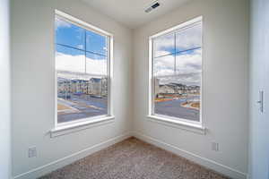 Popout playroom/home office. carpet flooring, baseboards, a residential view, and visible vents