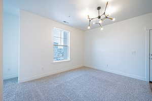 Unfurnished room with visible vents, baseboards, a chandelier, a textured ceiling, and carpet floors