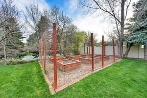View of yard featuring a garden and fence