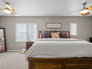 Bedroom with ceiling fan and carpet flooring