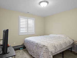 Bedroom with light colored carpet