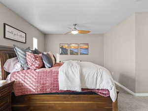 Carpeted bedroom with ceiling fan