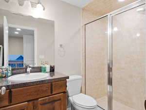 Bathroom featuring vanity, toilet, and walk in shower