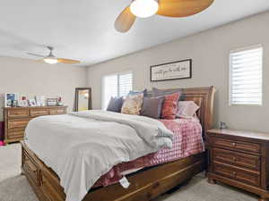 Carpeted bedroom with ceiling fan