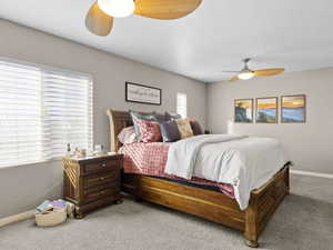 Bedroom with ceiling fan and carpet flooring