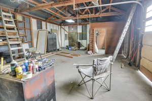 Miscellaneous room with vaulted ceiling and metal wall