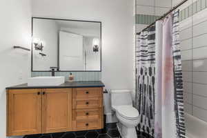 Bed 2 Bathroom featuring vanity, tile patterned flooring, toilet, and a shower with shower curtain