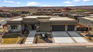 View of front of home featuring a residential view, stucco siding, a mountain view, and driveway