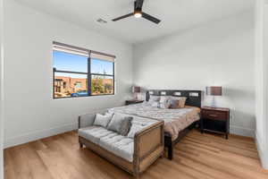 Bed #4 with ceiling fan, visible vents, baseboards, and wood finished floors