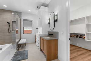 Primary Bathroom featuring vanity, recessed lighting, visible vents, baseboards, and walk in shower