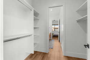 Bed 3 Spacious closet featuring light wood-style floors