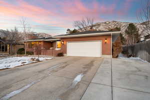 Ranch-style house with a mountain view and a garage