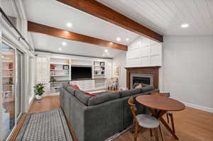 Living room featuring lofted ceiling with beams and light wood-type flooring