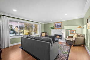 Living room featuring light wood-type flooring and ornamental molding