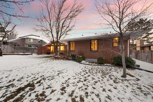 View of snow covered rear of property