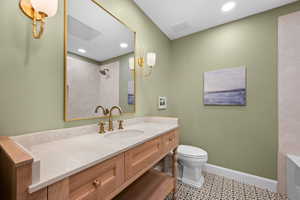 Bathroom with a shower, toilet, and vanity