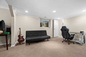 Carpeted home office with ornamental molding