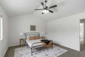 Bedroom featuring carpet, lofted ceiling, and ceiling fan