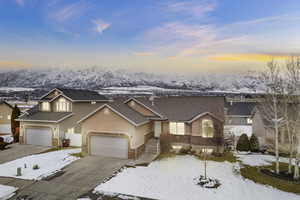 Front of property featuring a mountain view and a garage