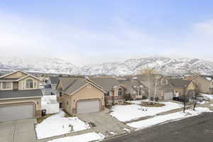 View of front facade featuring a mountain view and a garage