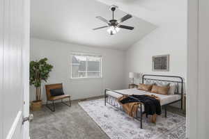 Carpeted bedroom featuring lofted ceiling and ceiling fan