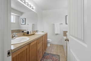 Bathroom with tile patterned flooring, vanity, and toilet