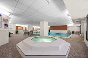 View of swimming pool with an indoor hot tub