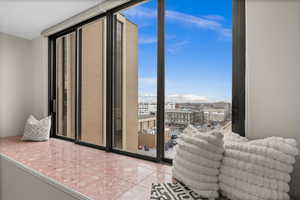 Interior space featuring a wall of windows and tile patterned flooring