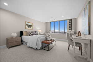 Bedroom featuring light colored carpet