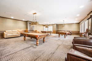 Recreation room with carpet floors, ornamental molding, and billiards