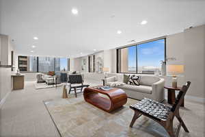 Living room with light carpet and floor to ceiling windows