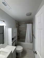 Full bathroom with toilet, vanity, shower / tub combo, and hardwood / wood-style floors