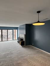 Unfurnished living room featuring carpet