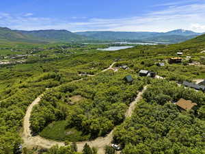 Drone / aerial view featuring a water and mountain view