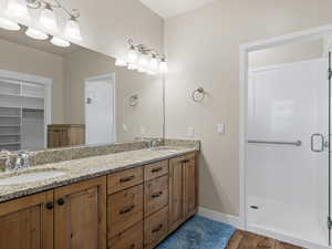 Master bath with walk-in shower w/bench and dual vanities.