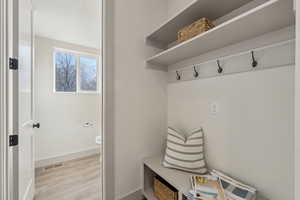 Mudroom with light hardwood / wood-style flooring