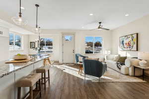 Living room featuring dark wood-type flooring and ceiling fan