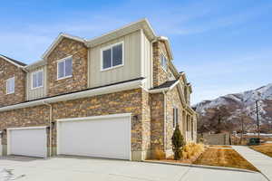 View of front of house with a garage and a mountain view