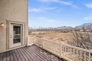 Wooden deck featuring a mountain view and open space.