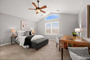 Bedroom with lofted ceiling, light colored carpet, and ceiling fan