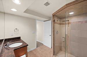 3/4 Bathroom featuring tile patterned floors, vanity, and walk in shower