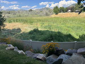 View of yard and full open space behind featuring a mountain view.  No homes will be built behind.