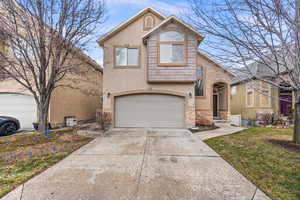 Front facade with a front lawn and a garage