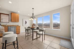 Tiled kitchen dining space featuring a mountain view and an inviting chandelier