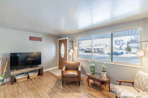 Living area featuring light wood-type flooring and baseboards