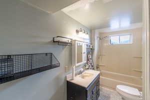 Bathroom with  shower combination, vanity, and toilet